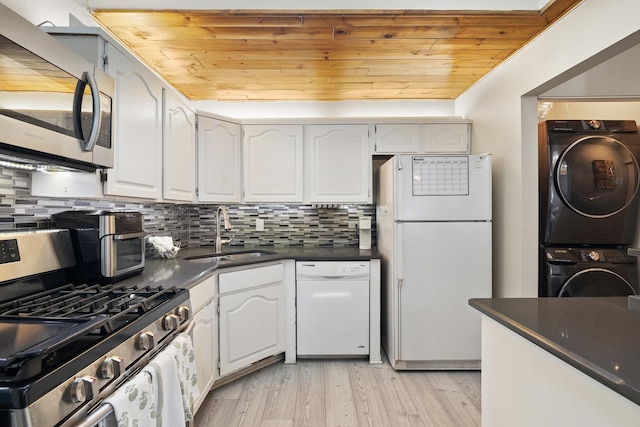 14515 Central Ct Unit Ph1, Oak Forest, IL 60452 - kitchen featuring appliances with stainless steel finishes, stacked washer / dryer, dark countertops, wooden ceiling, and light wood-style floors