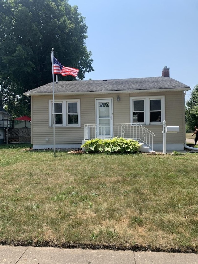 353 W Porter St, Oglesby, IL 61348 - view of front facade featuring a front lawn and a chimney