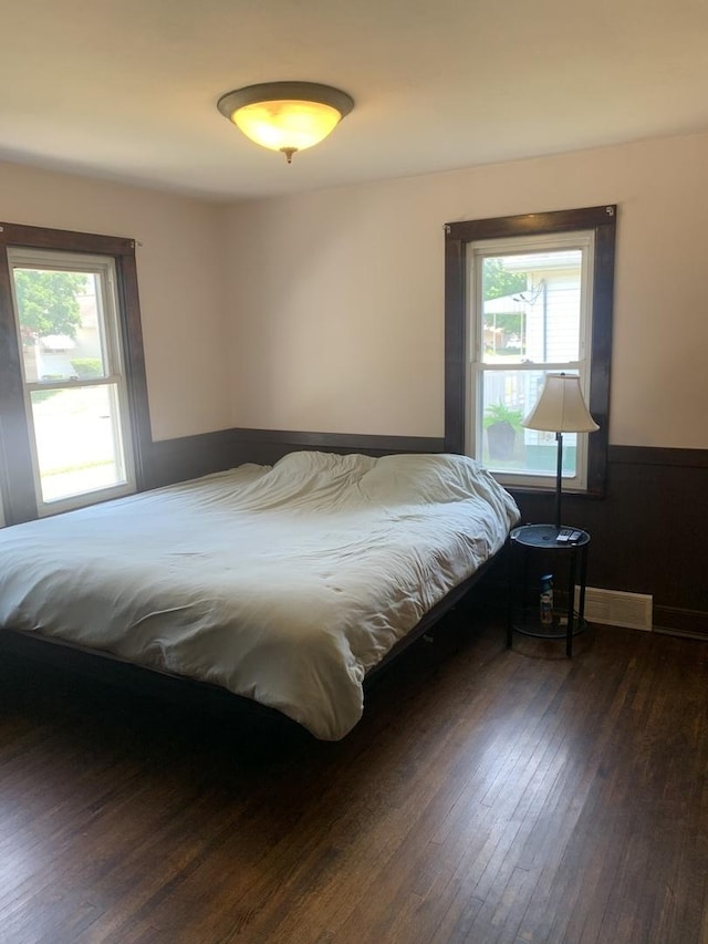 353 W Porter St, Oglesby, IL 61348 - bedroom with wood-type flooring, multiple windows, and a wainscoted wall