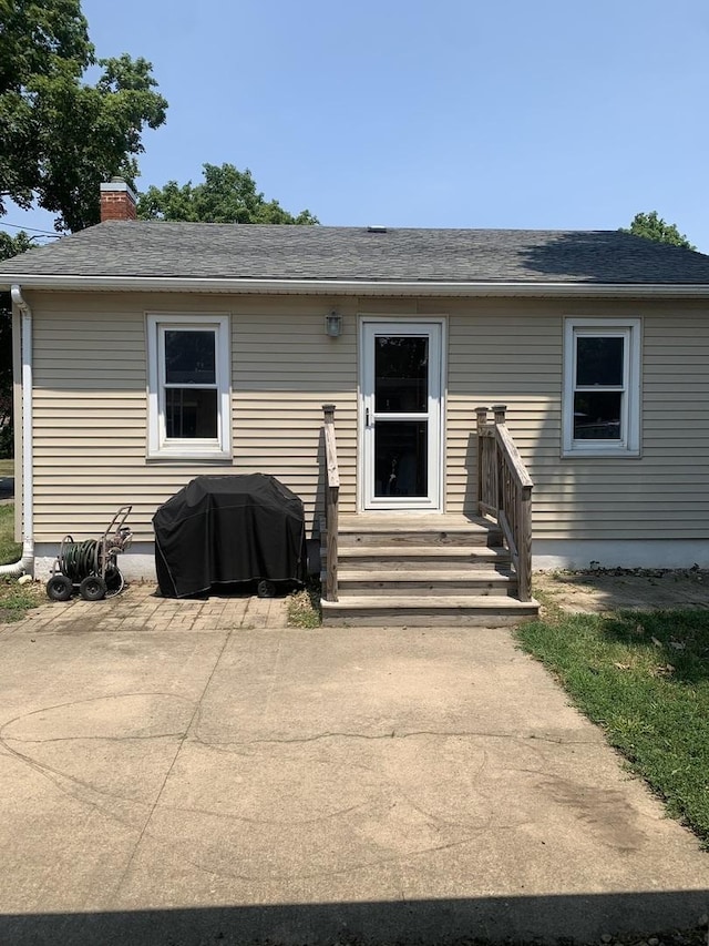 353 W Porter St, Oglesby, IL 61348 - back of house featuring a patio, a chimney, entry steps, and a shingled roof