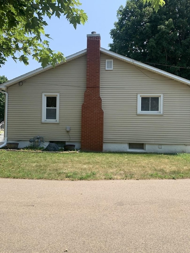353 W Porter St, Oglesby, IL 61348 - view of side of property featuring a chimney and a yard