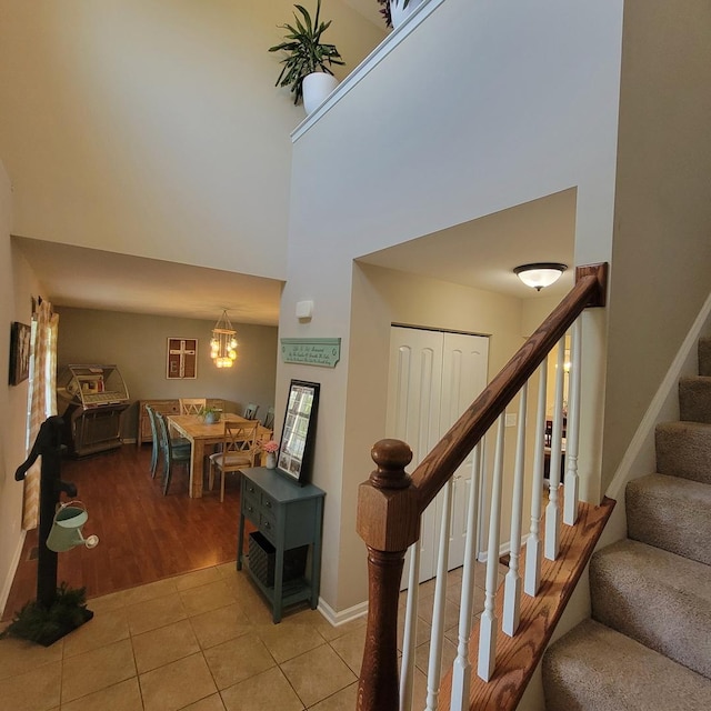 1506 Saddle Run Ln, Beecher, IL 60401 - staircase with a towering ceiling, tile patterned floors, and a chandelier