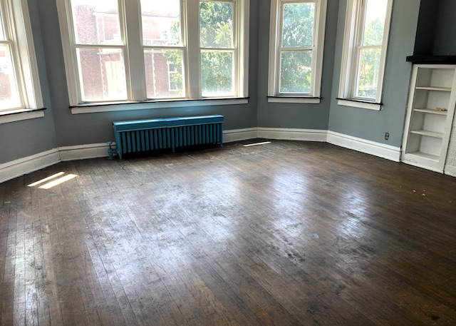108 W 81st St, Chicago, IL 60620 - empty room with radiator heating unit and dark wood finished floors