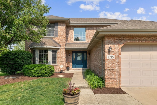 1215 Pendleton Dr, Lemont, IL 60439 - view of front of home with brick siding, a front yard, a garage, and roof with shingles