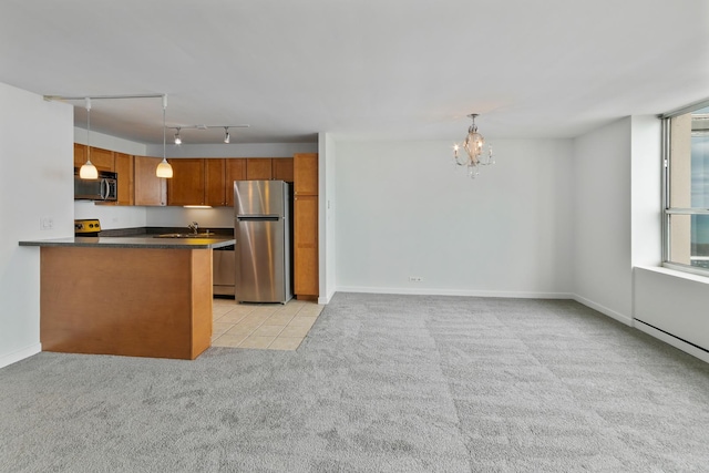 655 W Irving Park Rd Unit 4808, Chicago, IL 60613 - kitchen featuring appliances with stainless steel finishes, light carpet, a chandelier, dark countertops, and brown cabinets
