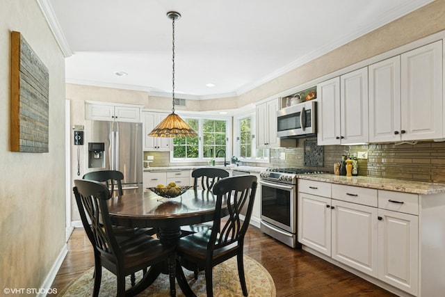 401 S Carlyle Pl, Arlington Heights, IL 60004 - kitchen featuring stainless steel appliances, crown molding, backsplash, pendant lighting, and dark wood-style flooring