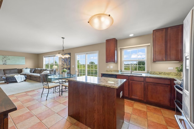 1644 Prairieview Blvd, Bolingbrook, IL 60490 - kitchen with a center island, light stone countertops, pendant lighting, open floor plan, and a chandelier