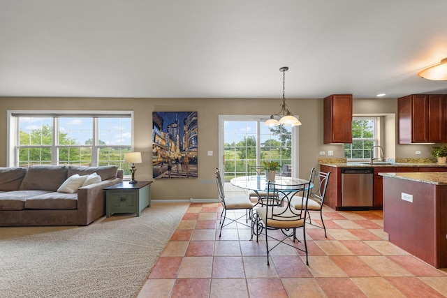 1644 Prairieview Blvd, Bolingbrook, IL 60490 - kitchen with stainless steel dishwasher, decorative light fixtures, light stone countertops, and open floor plan