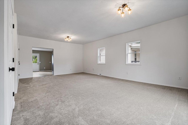 710 W Walnut St, Bloomington, IL 61701 - carpeted empty room featuring baseboards