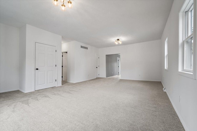 710 W Walnut St, Bloomington, IL 61701 - empty room featuring light carpet and baseboards