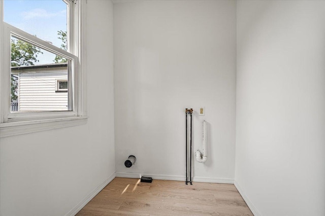 710 W Walnut St, Bloomington, IL 61701 - laundry room with light wood-style floors and baseboards