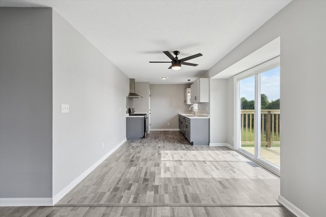 113 New Brunswick Ln, Poplar Grove, IL 61065 - kitchen with wall chimney range hood, stainless steel range oven, light countertops, a ceiling fan, and light wood finished floors