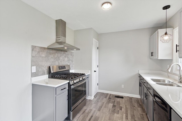 113 New Brunswick Ln, Poplar Grove, IL 61065 - kitchen featuring wall chimney range hood, stainless steel gas stove, black dishwasher, light wood-type flooring, and backsplash