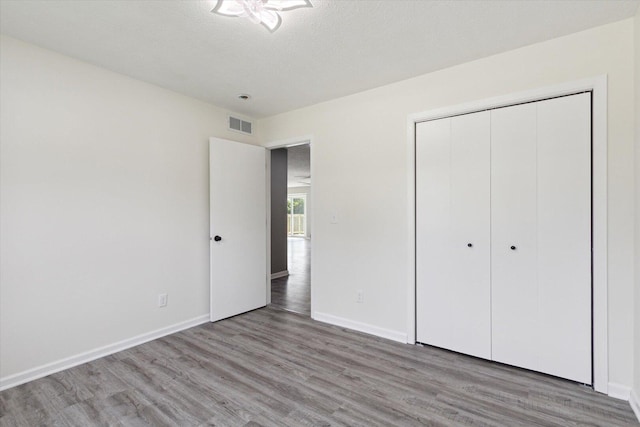 113 New Brunswick Ln, Poplar Grove, IL 61065 - unfurnished bedroom featuring light wood-type flooring and a closet