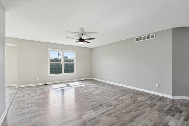 113 New Brunswick Ln, Poplar Grove, IL 61065 - unfurnished room with wood finished floors, a ceiling fan, and a textured ceiling