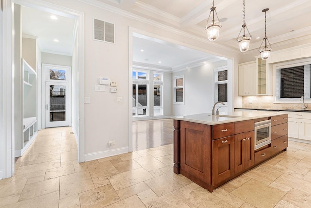 2632 N Talman Ave, Chicago, IL 60647 - kitchen featuring stainless steel microwave, stone tile flooring, decorative backsplash, an island with sink, and recessed lighting