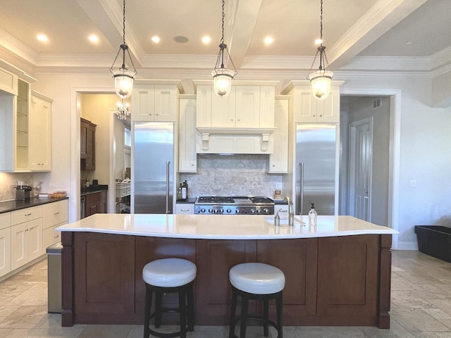 2632 N Talman Ave, Chicago, IL 60647 - kitchen with stainless steel built in fridge, stove, tasteful backsplash, stone tile flooring, and crown molding