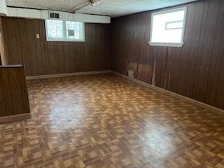 401 23rd Ave, Bellwood, IL 60104 - below grade area featuring wooden walls and healthy amount of natural light