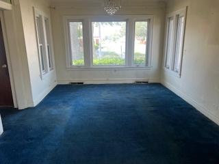 401 23rd Ave, Bellwood, IL 60104 - spare room with dark carpet and baseboards