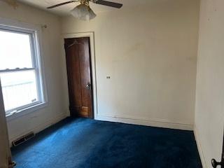 401 23rd Ave, Bellwood, IL 60104 - carpeted empty room featuring a ceiling fan and healthy amount of natural light