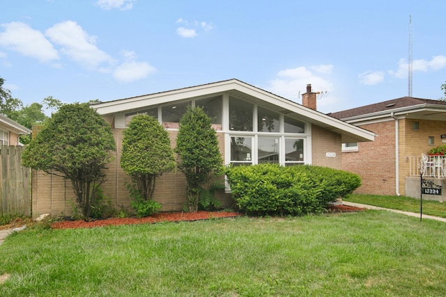 15224 Oak St, Dolton, IL 60419 - view of home's exterior with brick siding, a chimney, and a sunroom