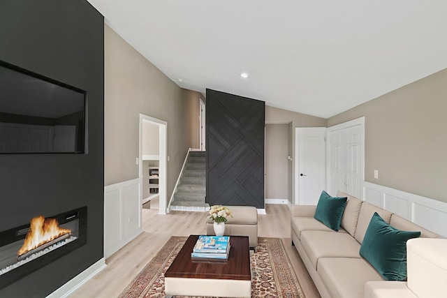 15224 Oak St, Dolton, IL 60419 - living room featuring vaulted ceiling, light wood-type flooring, a glass covered fireplace, stairs, and recessed lighting