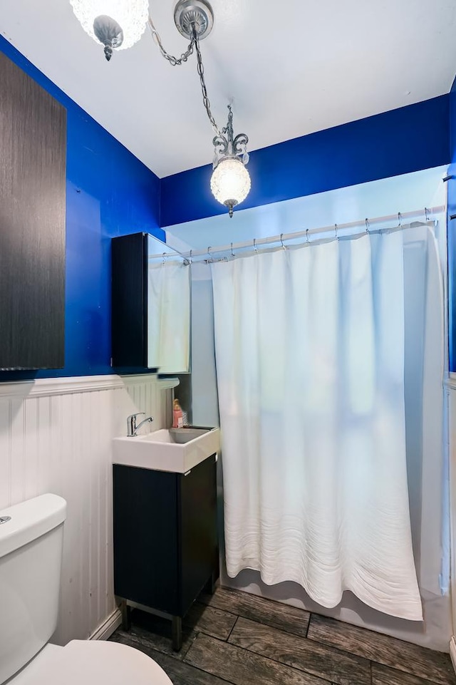 7010 W 72nd St, Chicago, IL 60638 - bathroom featuring vanity, wood finished floors, and a wainscoted wall