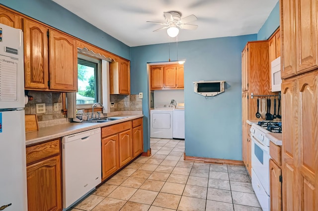 7010 W 72nd St, Chicago, IL 60638 - kitchen featuring white appliances, washing machine and clothes dryer, ceiling fan, backsplash, and light countertops