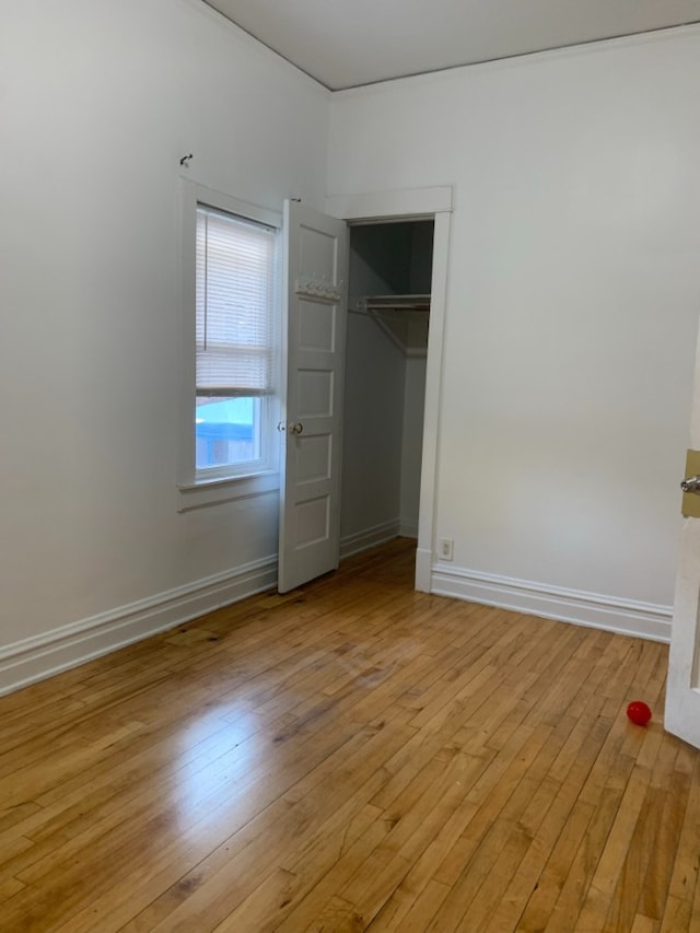 3255 N Kenneth Ave, Chicago, IL 60641 - unfurnished bedroom with light wood-style flooring and a closet