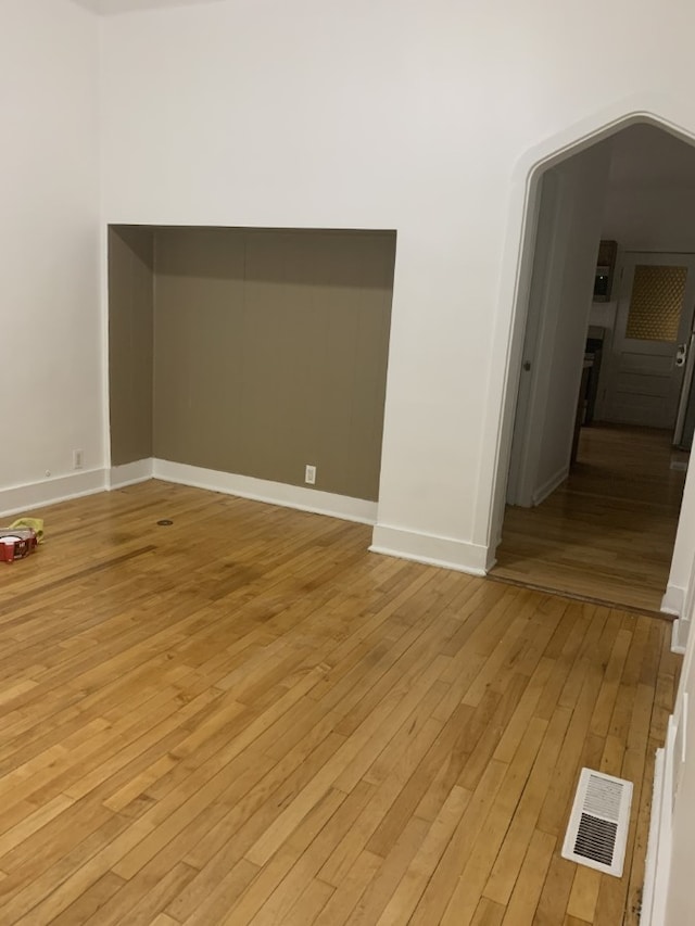3255 N Kenneth Ave, Chicago, IL 60641 - unfurnished room featuring light wood-style floors and arched walkways