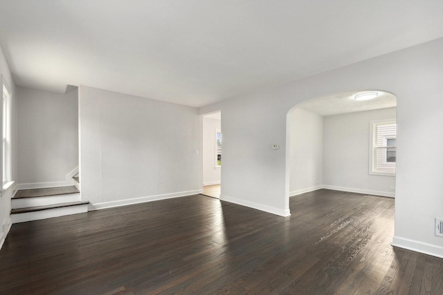 1225 Highridge Pkwy, Westchester, IL 60154 - empty room featuring arched walkways, dark wood-style flooring, and stairway