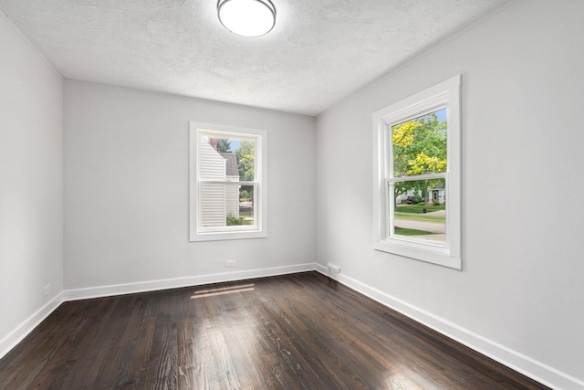1225 Highridge Pkwy, Westchester, IL 60154 - unfurnished room with plenty of natural light, dark wood-style floors, and a textured ceiling