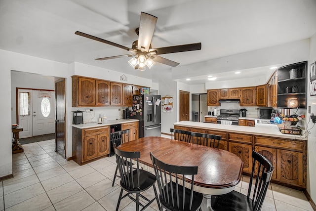 13460 185th St, Mokena, IL 60448 - kitchen with appliances with stainless steel finishes, light tile patterned floors, light countertops, ceiling fan, and a peninsula