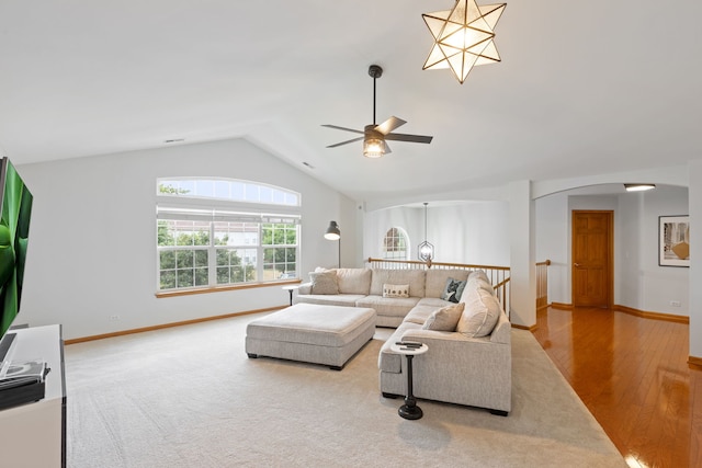 2599 Oak Dr Unit 2599, West Dundee, IL 60118 - living area featuring vaulted ceiling, a ceiling fan, arched walkways, and wood finished floors