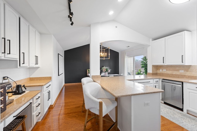 2599 Oak Dr Unit 2599, West Dundee, IL 60118 - kitchen featuring dishwasher, lofted ceiling, a chandelier, a peninsula, and white cabinets