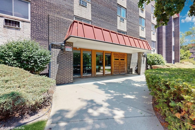 4700 Old Orchard Rd Unit 310, Skokie, IL 60076 - view of exterior entry featuring brick siding and a standing seam roof
