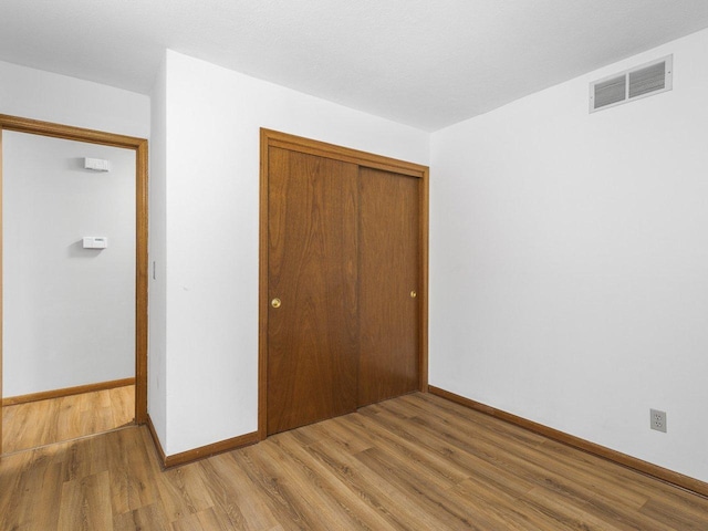 4176 Tumbleweed Trl Unit 0, Loves Park, IL 61111 - unfurnished bedroom featuring wood finished floors and a closet