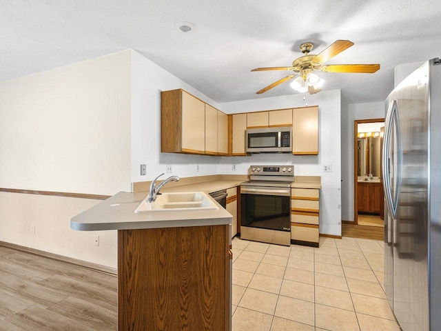 4176 Tumbleweed Trl Unit 0, Loves Park, IL 61111 - kitchen featuring appliances with stainless steel finishes, a peninsula, a ceiling fan, light countertops, and light tile patterned floors