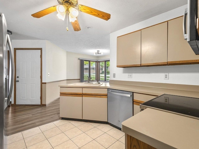 4176 Tumbleweed Trl Unit 0, Loves Park, IL 61111 - kitchen featuring stainless steel appliances, a ceiling fan, light tile patterned floors, light countertops, and a peninsula