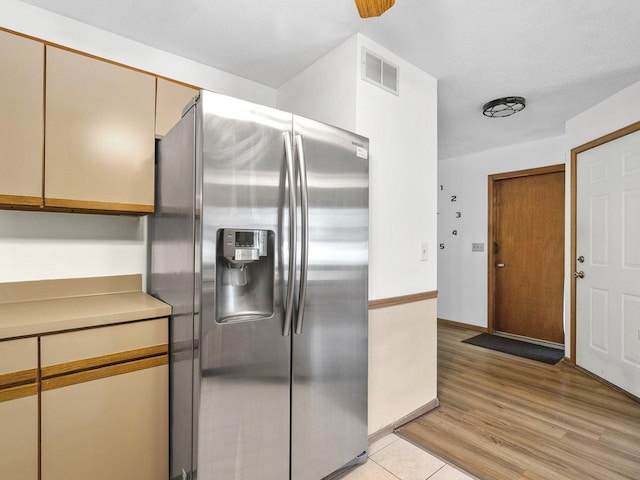 4176 Tumbleweed Trl Unit 0, Loves Park, IL 61111 - kitchen featuring stainless steel fridge, light wood-style floors, cream cabinets, and light countertops