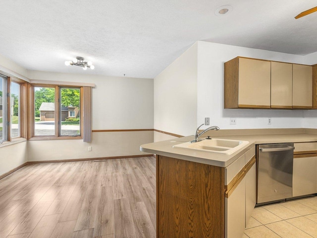 4176 Tumbleweed Trl Unit 0, Loves Park, IL 61111 - kitchen featuring stainless steel dishwasher, light countertops, light wood finished floors, a textured ceiling, and a peninsula