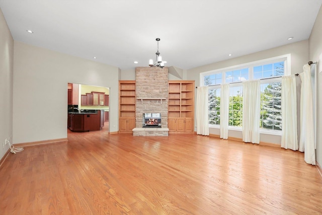 6443 Davane Ct, Downers Grove, IL 60516 - unfurnished living room with a chandelier, light wood-style floors, a stone fireplace, and recessed lighting