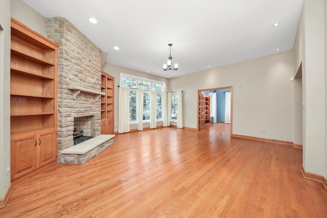 6443 Davane Ct, Downers Grove, IL 60516 - unfurnished living room featuring a stone fireplace, light wood-style floors, a chandelier, and recessed lighting