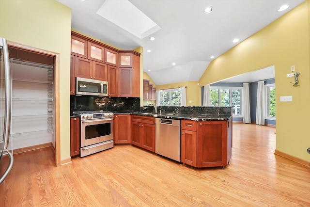 6443 Davane Ct, Downers Grove, IL 60516 - kitchen featuring stainless steel appliances, a peninsula, a skylight, light wood finished floors, and tasteful backsplash