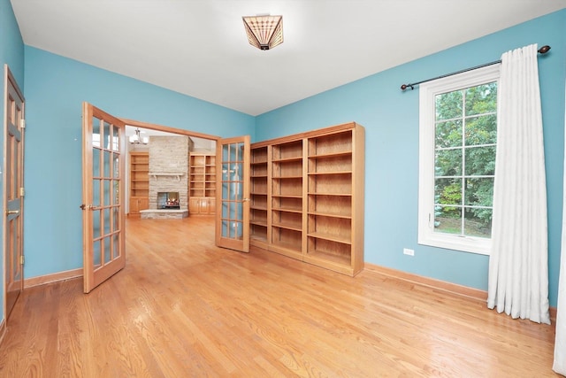 6443 Davane Ct, Downers Grove, IL 60516 - unfurnished room with french doors, wood finished floors, and a fireplace