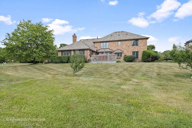 3250 Platte Trl, Olympia Fields, IL 60461 - back of house with brick siding, a chimney, a wooden deck, and a yard