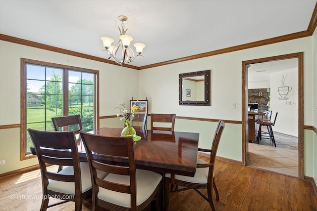 3250 Platte Trl, Olympia Fields, IL 60461 - dining area featuring a chandelier, light wood finished floors, and ornamental molding