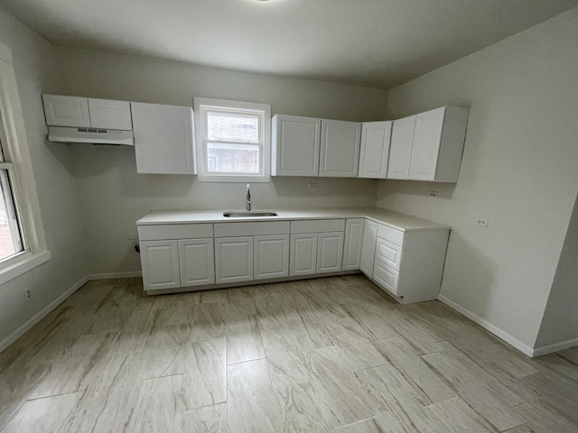 5229 S Campbell Ave, Chicago, IL 60632 - kitchen featuring white cabinets, under cabinet range hood, and light countertops