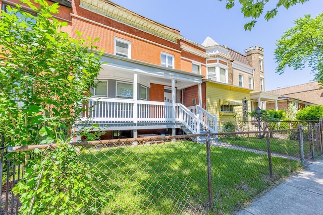 1310 E 72nd St, Chicago, IL 60619 - view of front of house with a porch, brick siding, and a fenced front yard