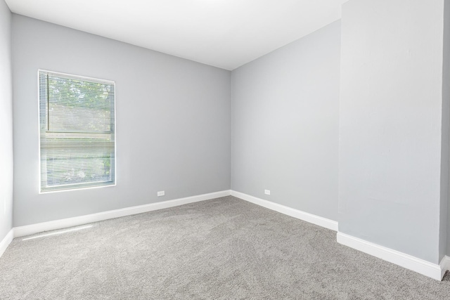 1310 E 72nd St, Chicago, IL 60619 - carpeted empty room with baseboards